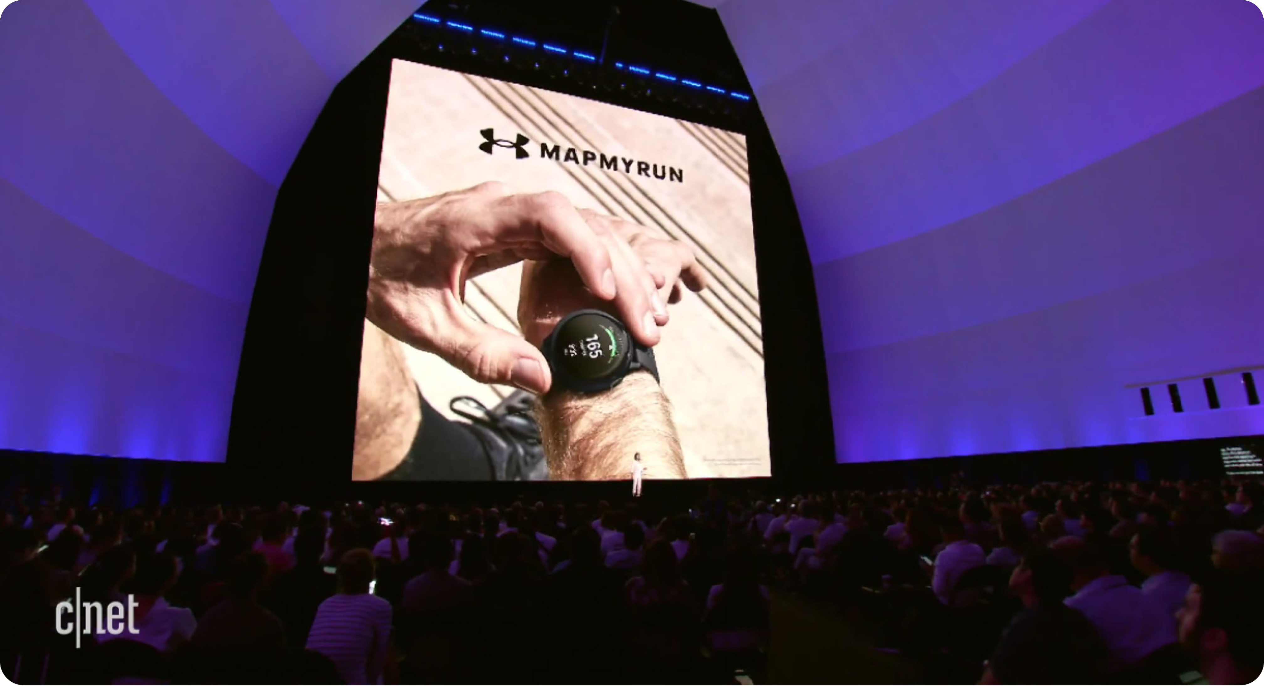 Samsung Unpacked conference stage showing the UA MapMyRun watch reveal