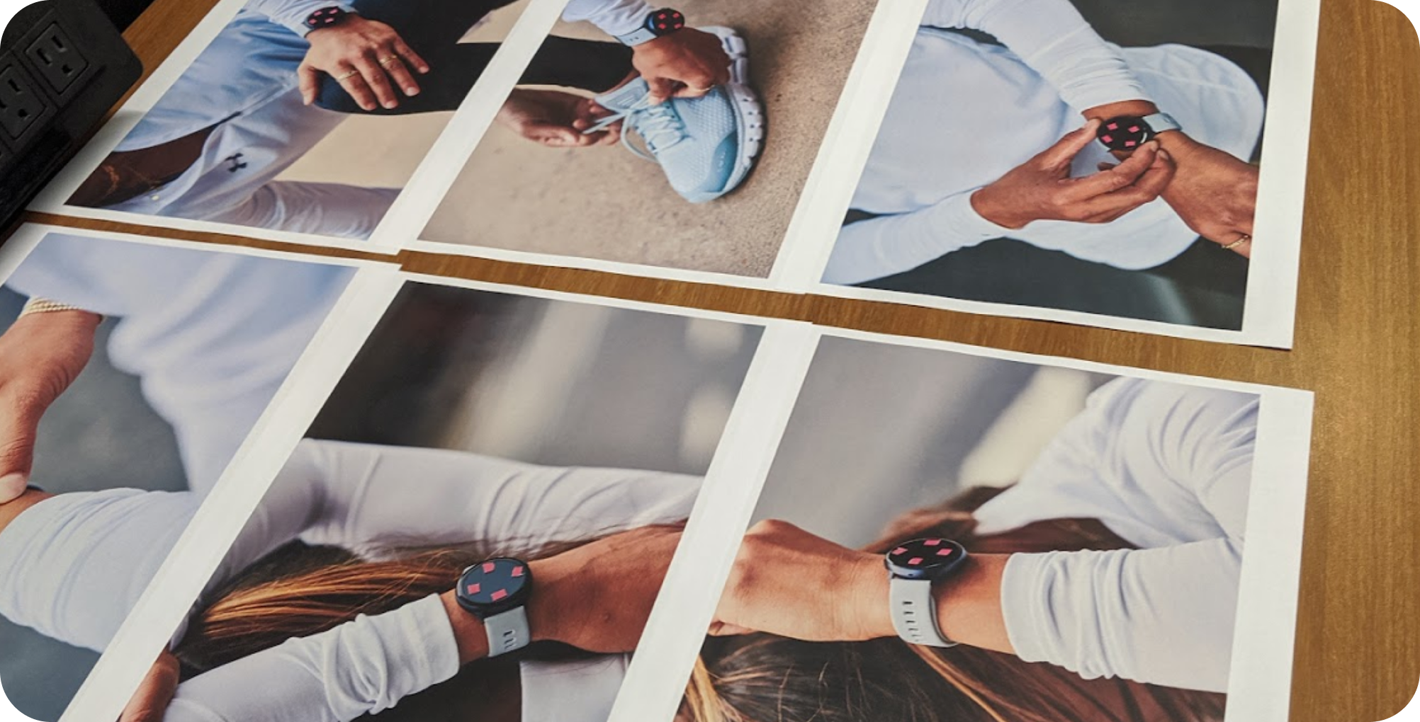 Printed marketing photo proofs of the watch on-wrist, laid out for review